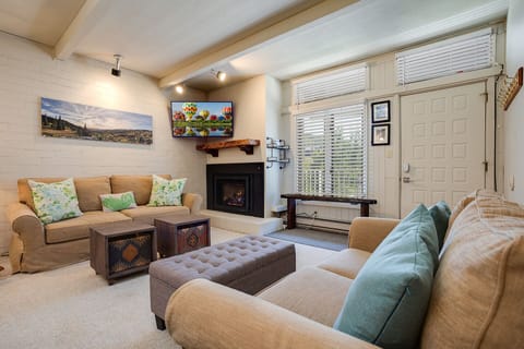 Sink into plush seating by the fireplace, where warm lighting and mountain views create your perfect retreat for relaxing evenings.