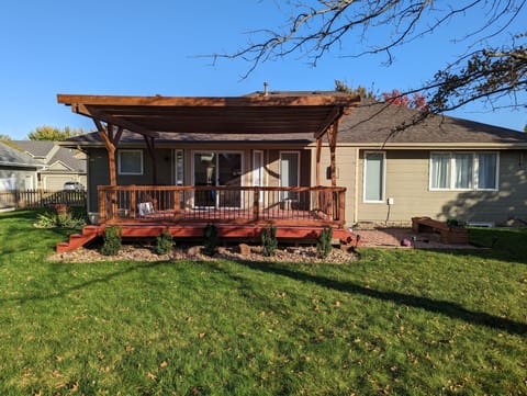 Back yard with deck, pergola, and paver patio. Fenced in for pets! 
