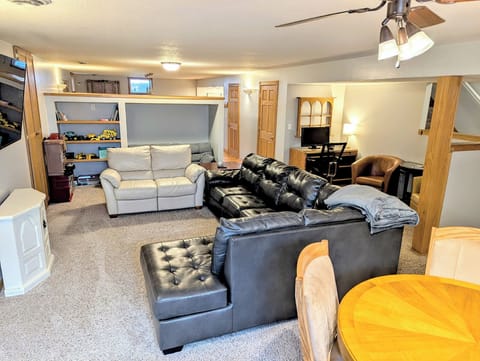 Lower level living w/ kids toys, workstation, card/bumper pool table, & seating.