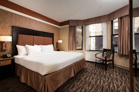 Unwind in a sunlit king room with cozy seating.