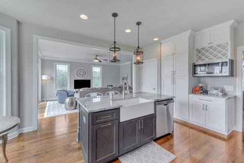 Large farmhouse sink with garbage disposal. Kitchen supplies are provided