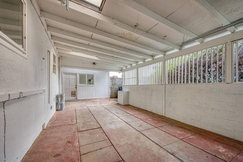 The driveway is on the right side of the property and there is a carport with a garage door for 1 covered parking spot.