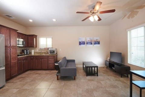 Open space- Kitchen, living room with 55" TV, Roku, dining table, and chair.