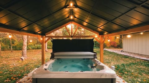 Relax in the hot tub while colorful autumn foliage surrounds you.