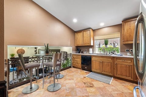 Discover the heart of the home in this well-equipped kitchen featuring a charming coffee nook, perfect for your morning brew. The kitchen offers a spacious layout and modern appliances for preparing delicious meals. 