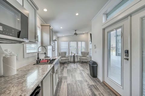 This tiny home is big on comfort with a cozy living area, kitchenette with microwave, mini-fridge and coffee pot, a bedroom with a King bed and a bathroom with a spacious walk-in shower.