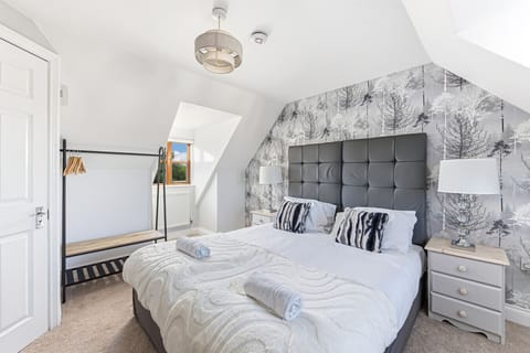 Bedroom 1 has a private en-suite shower, a smart TV, a dressing table and a comfortable zip-link bed set up as two single beds by default or can be zipped together to form a king-size bed upon request.