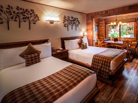 Double Studio Cabin features two double beds, mini fridge, microwave, flat screen TV, seating area, hard floors, and shower with a bathtub.