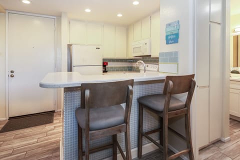 Two chairs at the bar, perfect for younger guests or for quick bites.