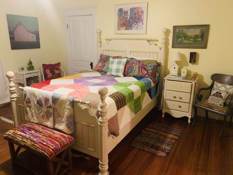 Light filled colorful antique Boho style, queen bed