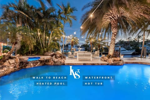 Waterfront Resort Style Oasis with Salt Water Heated Pool, Spa,  FIre Pit, Tiki Hut & Bar, Outdoor Kitchen, Outdoor Dining Area, 80' Deep Water Dock / Floating Dock with no fixed bridges to Intercoastal.  Plenty of Seating Areas, a Hammock & much mor