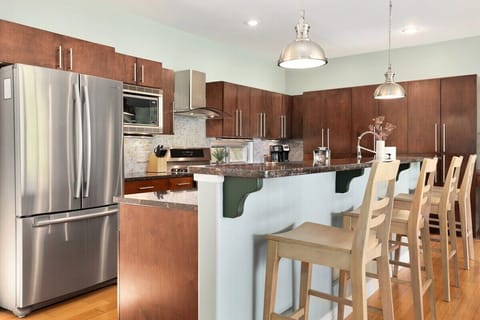 Here, you'll find high-end amenities, stunning black countertops, gorgeous dark wood cabinets and bar seating for 4.