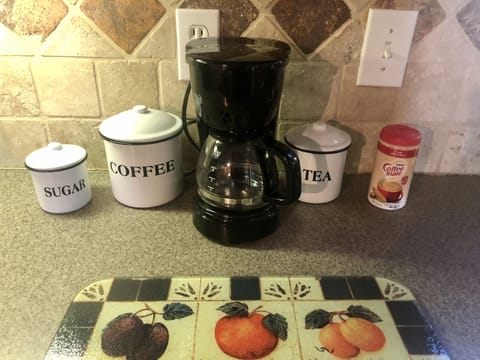 Coffee maker with coffee, sugar, creamer  and also tea bags and sweetener