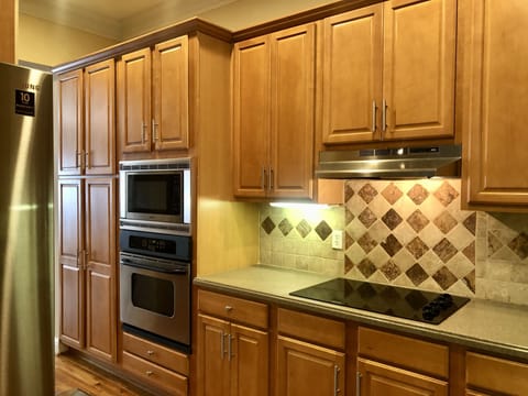 Kitchen with microwave, stove and electrical cooktop