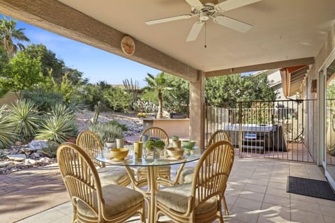 Covered backyard patio with dining, grill, and hot tub!