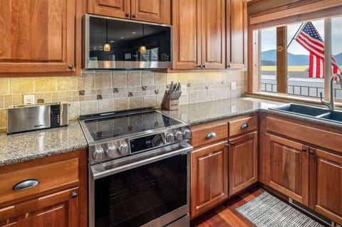 Kitchen is fully appointed and looks out to the water.