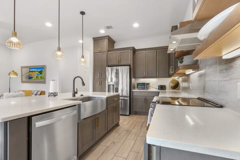 View showing the modern kitchen with stainless appliances.