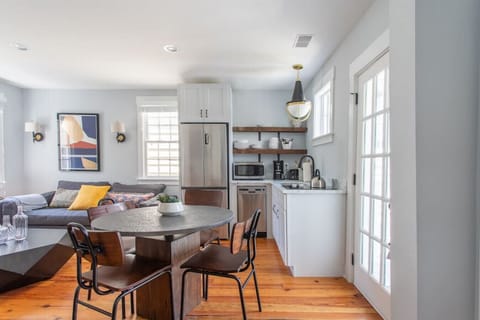 Upstairs Unit Kitchen - Prepare simple meals in our efficient kitchen, featuring a dedicated dining table for four.