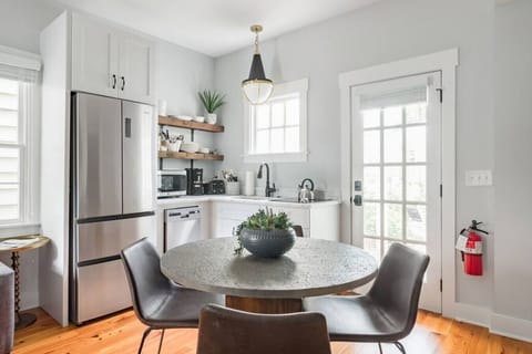 Downstairs Unit Kitchen - Prepare simple meals in our efficient kitchen, featuring a dedicated dining table for four.