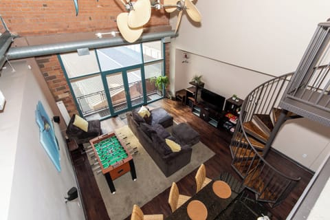 Relax in your stylish loft with exposed brick walls, cozy seating, and entertainment including foosball for memorable evenings.