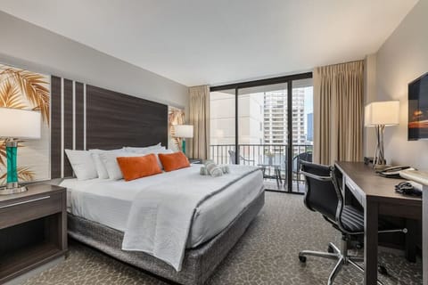 Bright bedroom retreat w/ cozy seating & soft light for easy unwind.