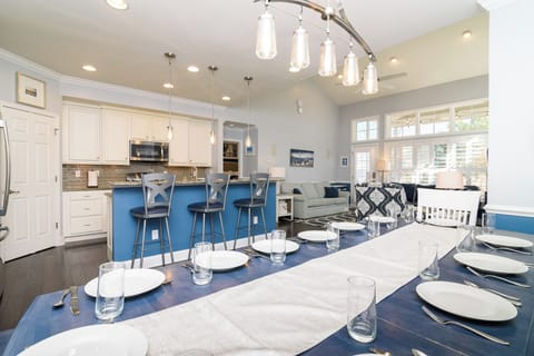 This large dining table includes seating for 12. Nearby breakfast bar seats 3.