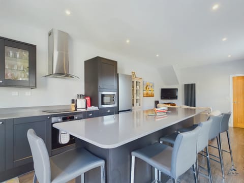 The heart of the home: a modern open-plan kitchen and sitting area, perfect for socialising while cooking.