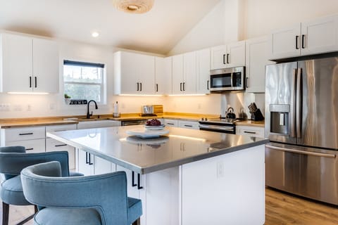 Keep the cook company at the spacious island and bar stools.