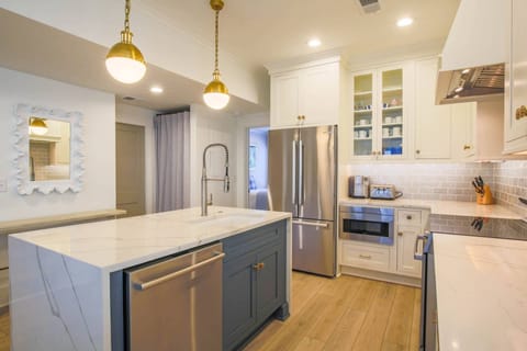 The kitchen has a dishwasher, refrigerator, microwave, toaster and oven.