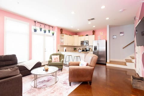 Bright, open, and oh-so-pink! This living space features a cozy sofa and chairs, a chic blush rug, and plenty of natural light. Perfect for sipping cocktails before hitting Broadway or lounging with the girls after a long day exploring Nashville.