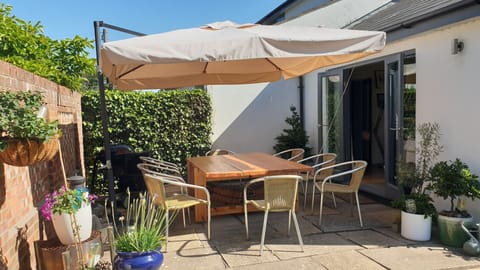 Our south facing patio table with seating for 8. Its a real suntrap.