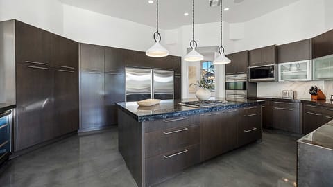 Modern kitchen with sleek cabinetry, large island, and high-end appliances.