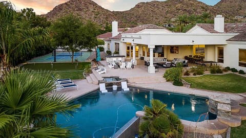 Large entertainment backyard w/ loungers, pool, spa, firepit, & games