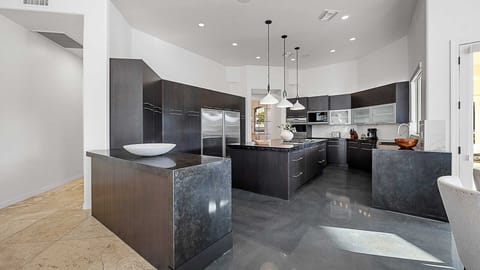 Immaculate extra large kitchen w/ unique black modern cabinets & large island
