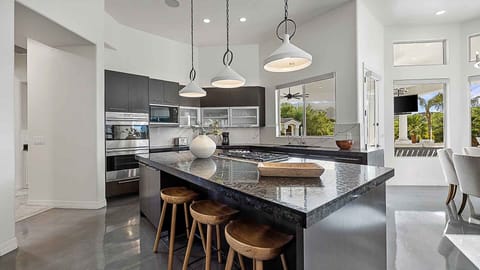 Modern kitchen with a large island, sleek cabinetry, and stunning window views.