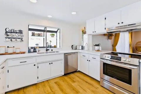 Large kitchen equipped with many essential cooking tools.