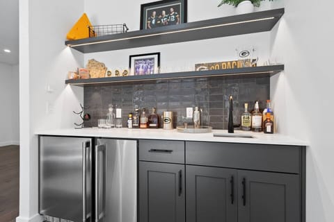 The second floor features an open concept kitchen with gourmet appliances, patio with teak dining set, walk-in pantry and formal dining area as well as an adjacent living room area with a gas fire place and wet bar.