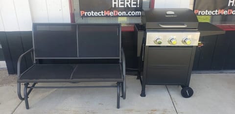 Enjoy outside on the covered patio.  Glider and grill out the front door.