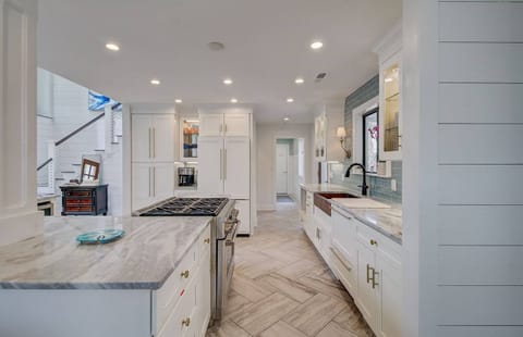 A chef's kitchen with stainless steel appliances and lots of cabinetry for storage.