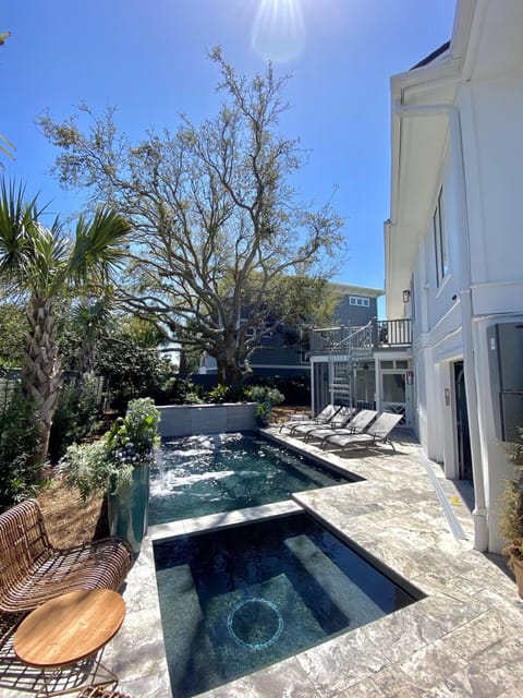 A private pool & hot tub greets you after a long, salty day at the beach!