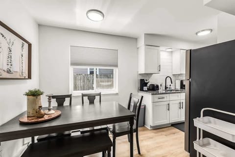 Kitchen dining table features 4 chairs. Window has blinds for privacy / light blocking