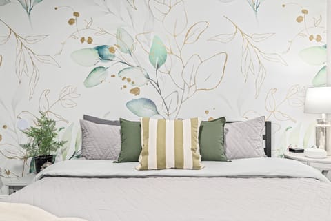 Luxury King Suite features plush pillows and professional design