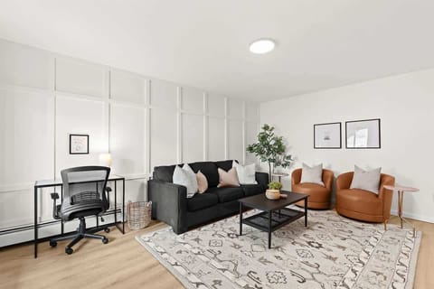 Bright, modern living room with work-from-home desk and plenty of cozy seating.