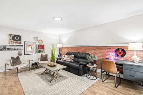 Cozy living area with comfy leather couch and work space desk