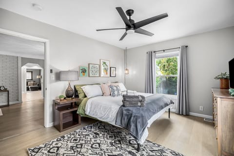 Master Bedroom features King Bed, luxury linens, extra pillows, black out curtains, smart TV, and extra storage!