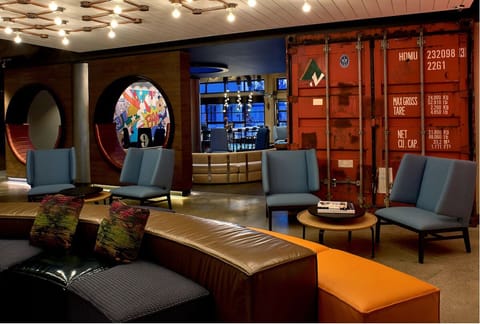Relax into cozy nooks with bold art and warm lighting.