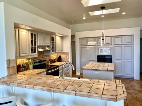 The spacious, well-stocked kitchen and open floor plan support social connection around food and celebration