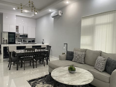 Living room with sofa bed and dining area.