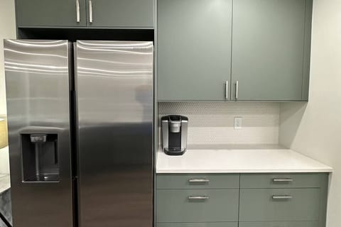Full size fridge/freezer and coffee bar with Keurig machine.