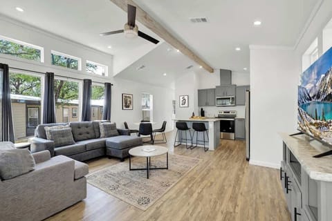 The open concept tiny home boasts a stylish living space, kitchen, and dining area, where every square inch is thoughtfully designed for both aesthetics and functionality.